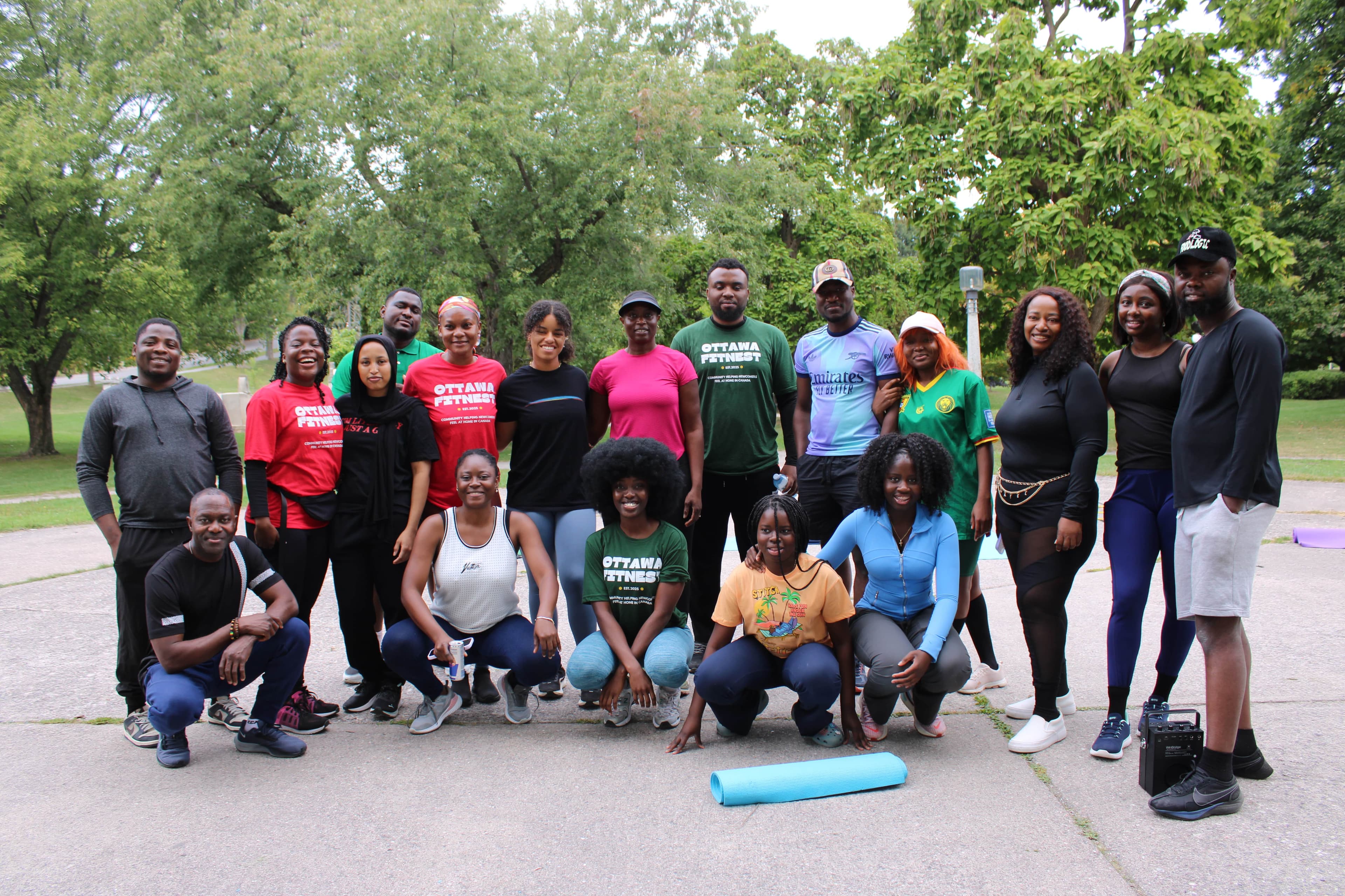 A large group in Ottawa Fitnest shirts gathered in a park after a bootcamp